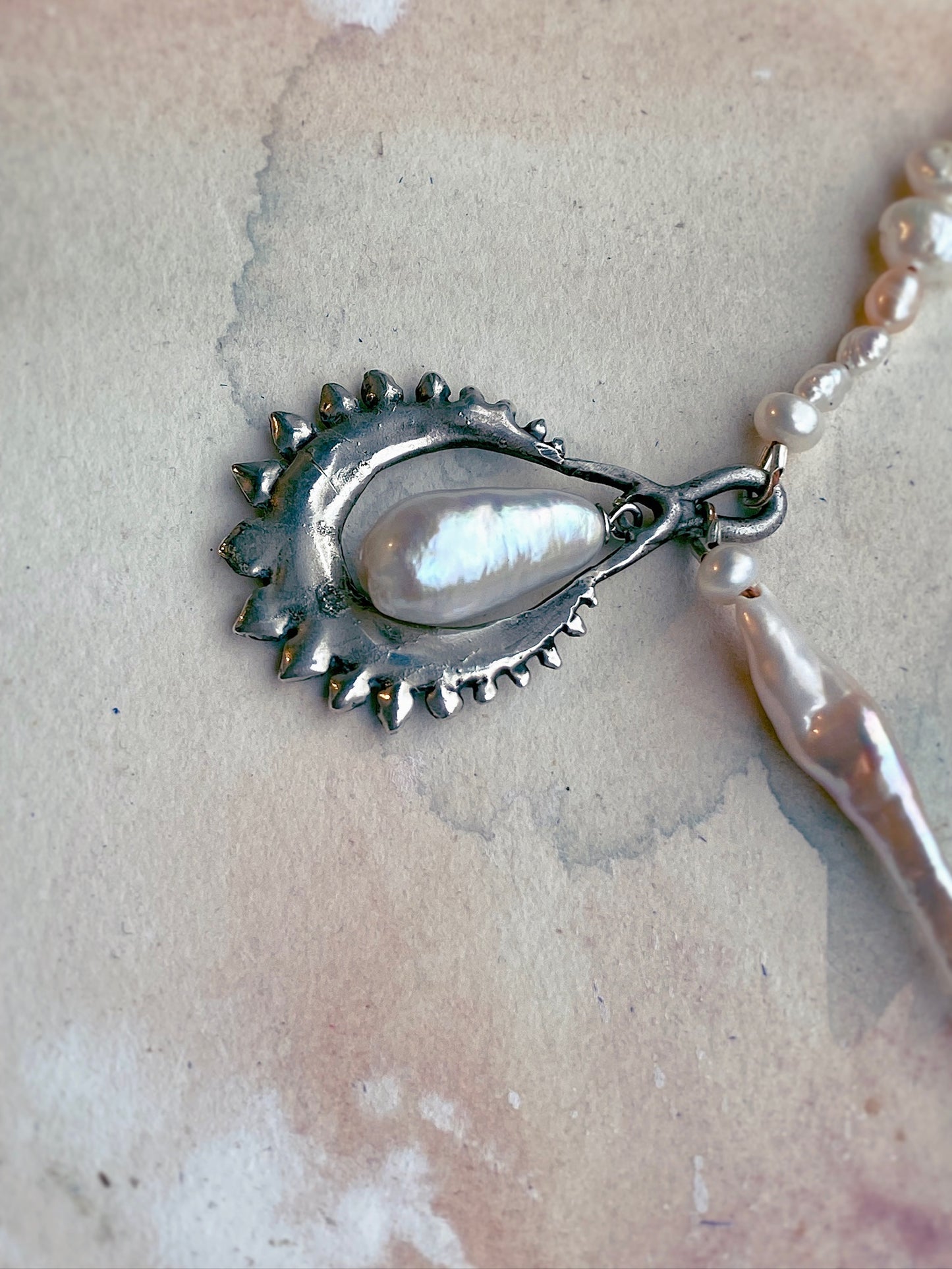 moon cradled fresh water pearl on textured strand