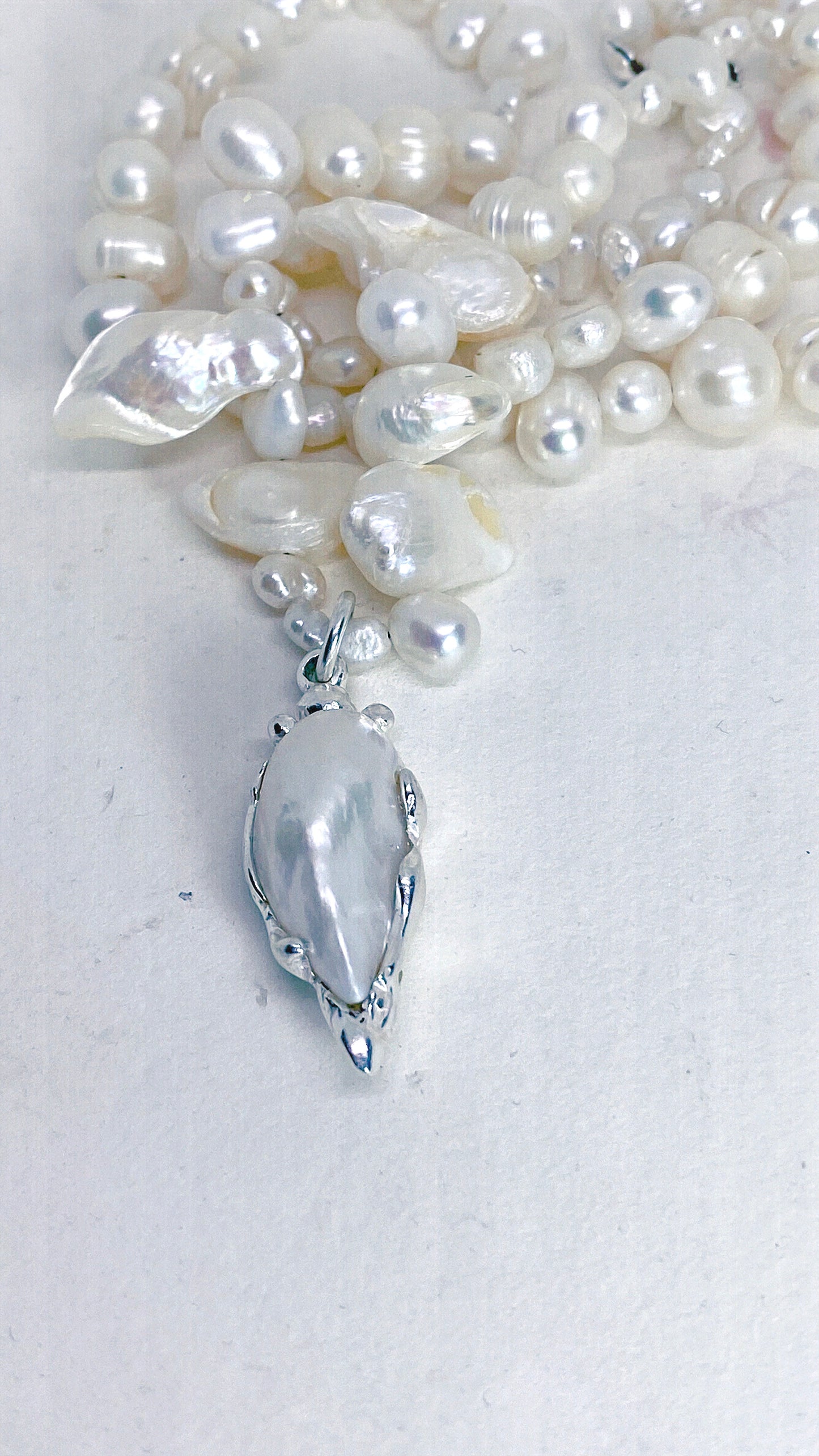 baroque blister teardrop pendant on flowing fresh water pearl strand