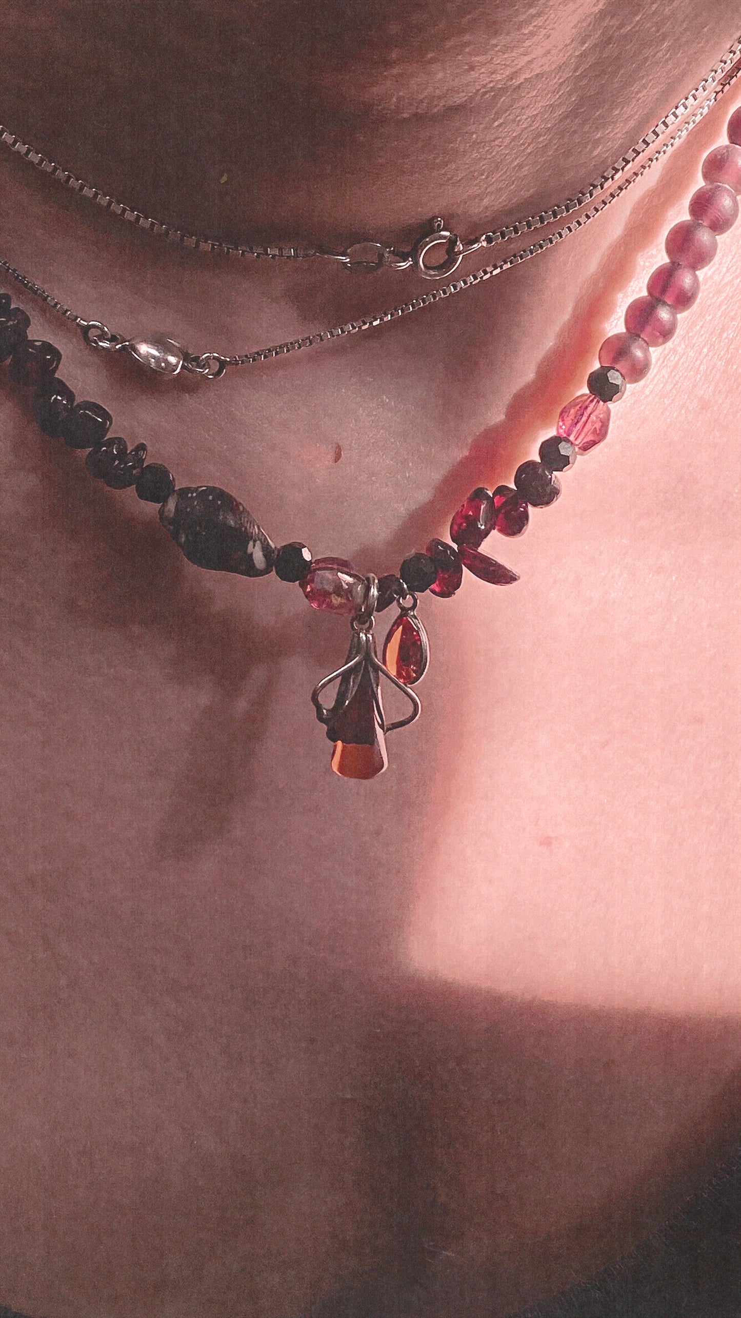 amber droplet and mini fire droplet on textured garnet, seashell, glass
