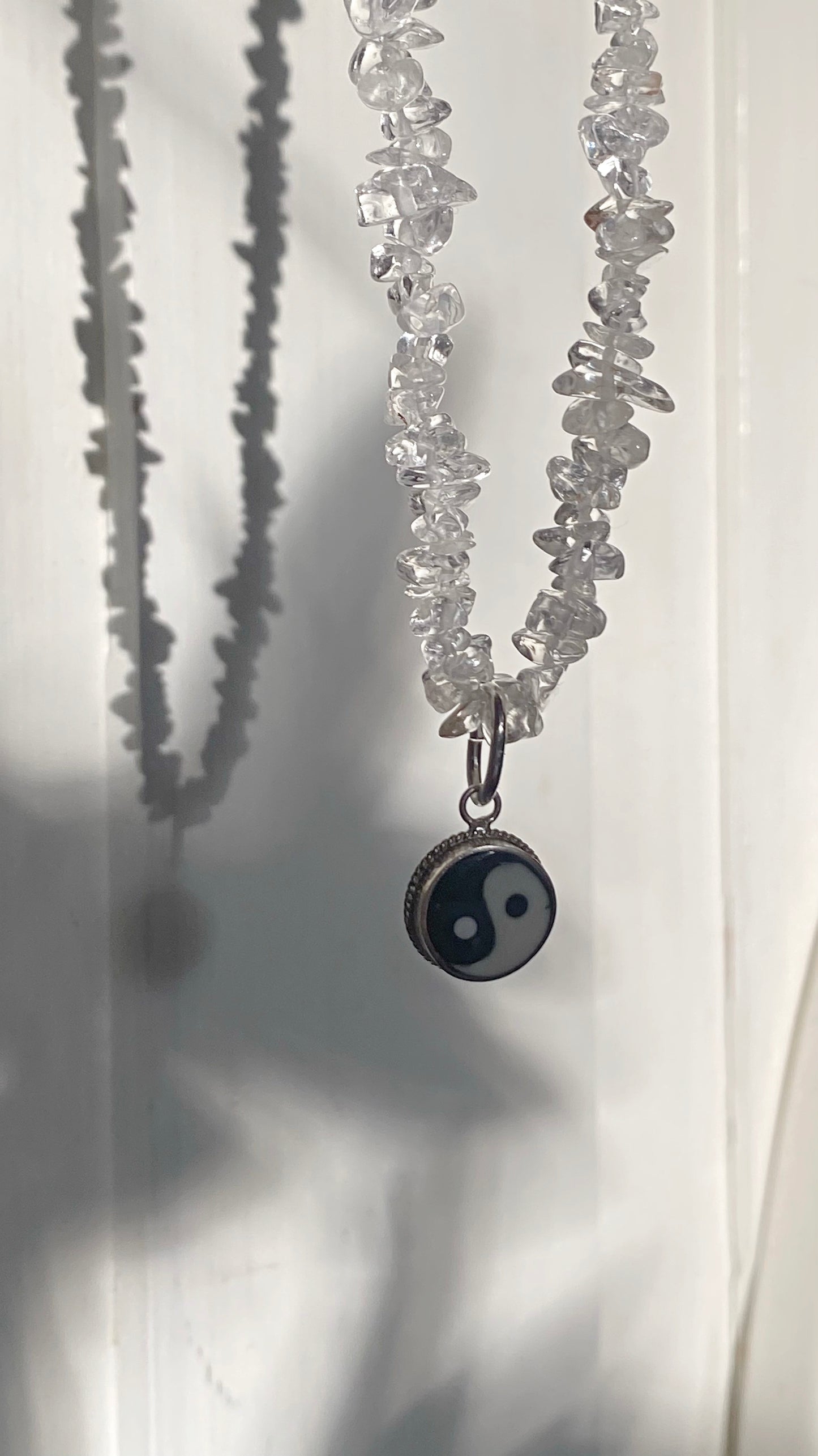 vintage yin and yang silver pendant on radiant clear quartz