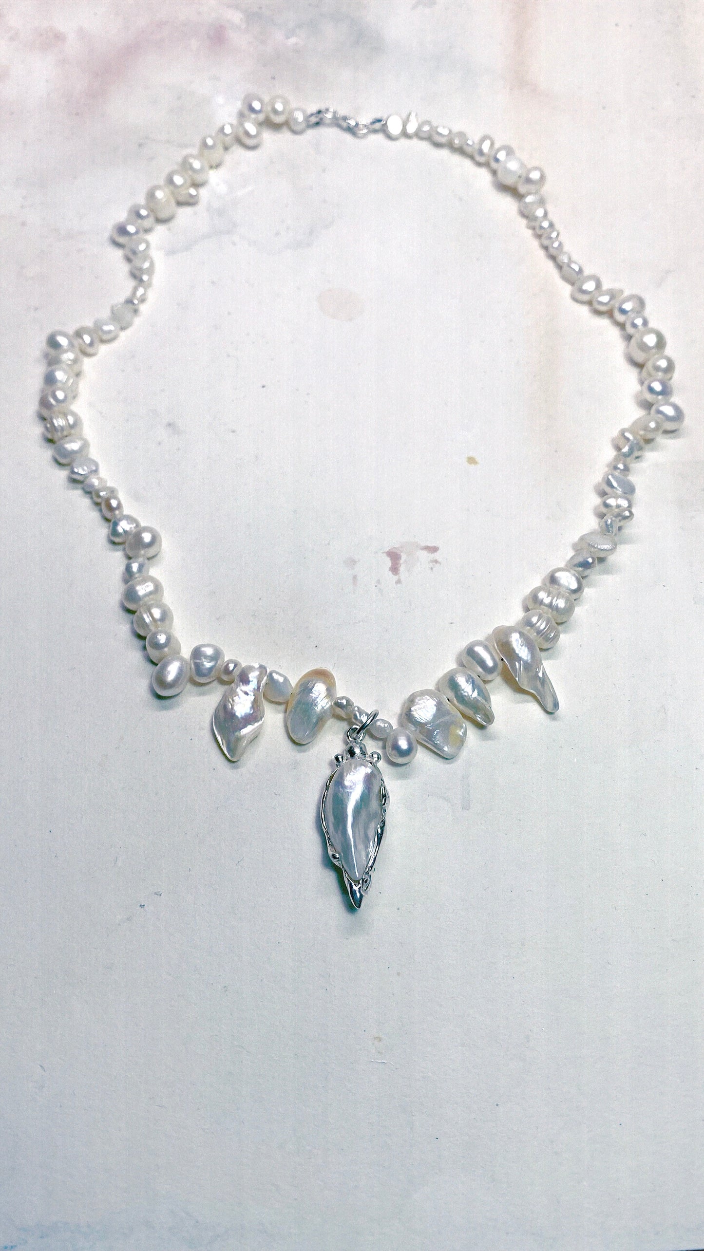 baroque blister teardrop pendant on flowing fresh water pearl strand