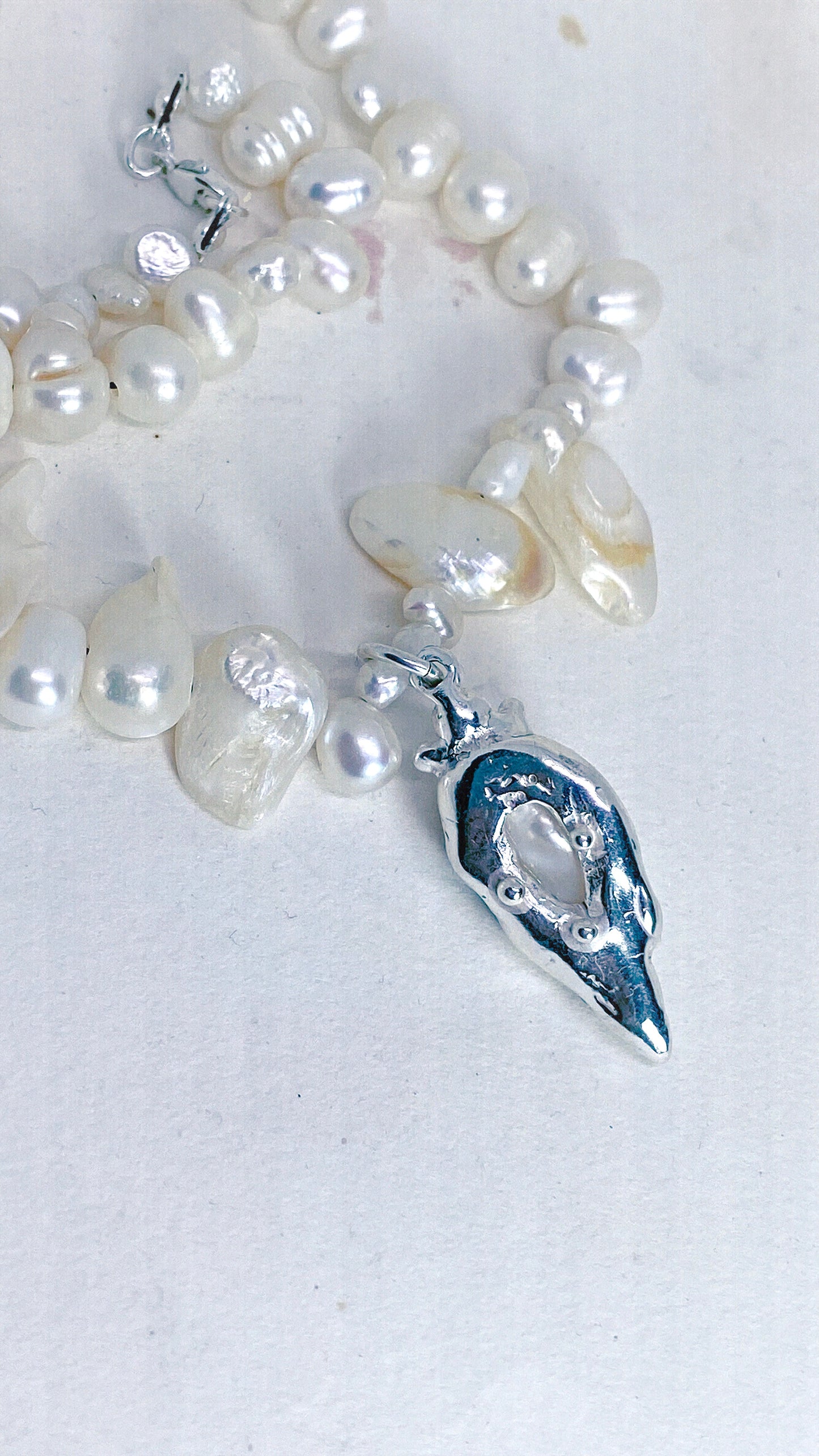 baroque blister teardrop pendant on flowing fresh water pearl strand