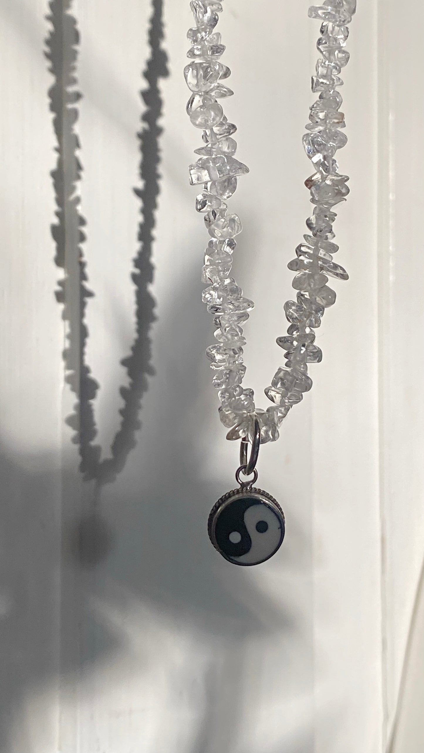 vintage yin and yang silver pendant on radiant clear quartz