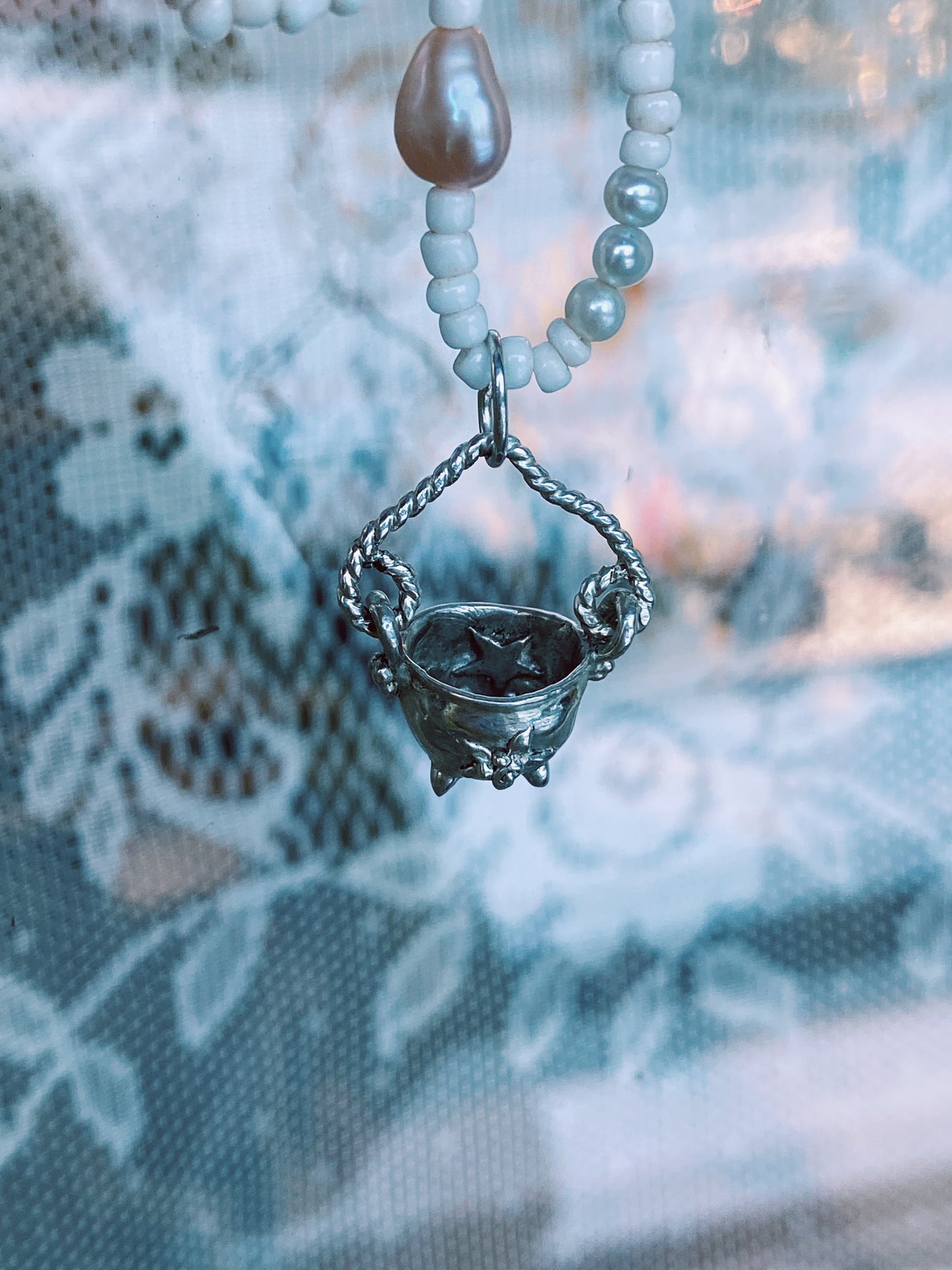 (reserved) shining sea // luminescent silver cauldron on beaded string