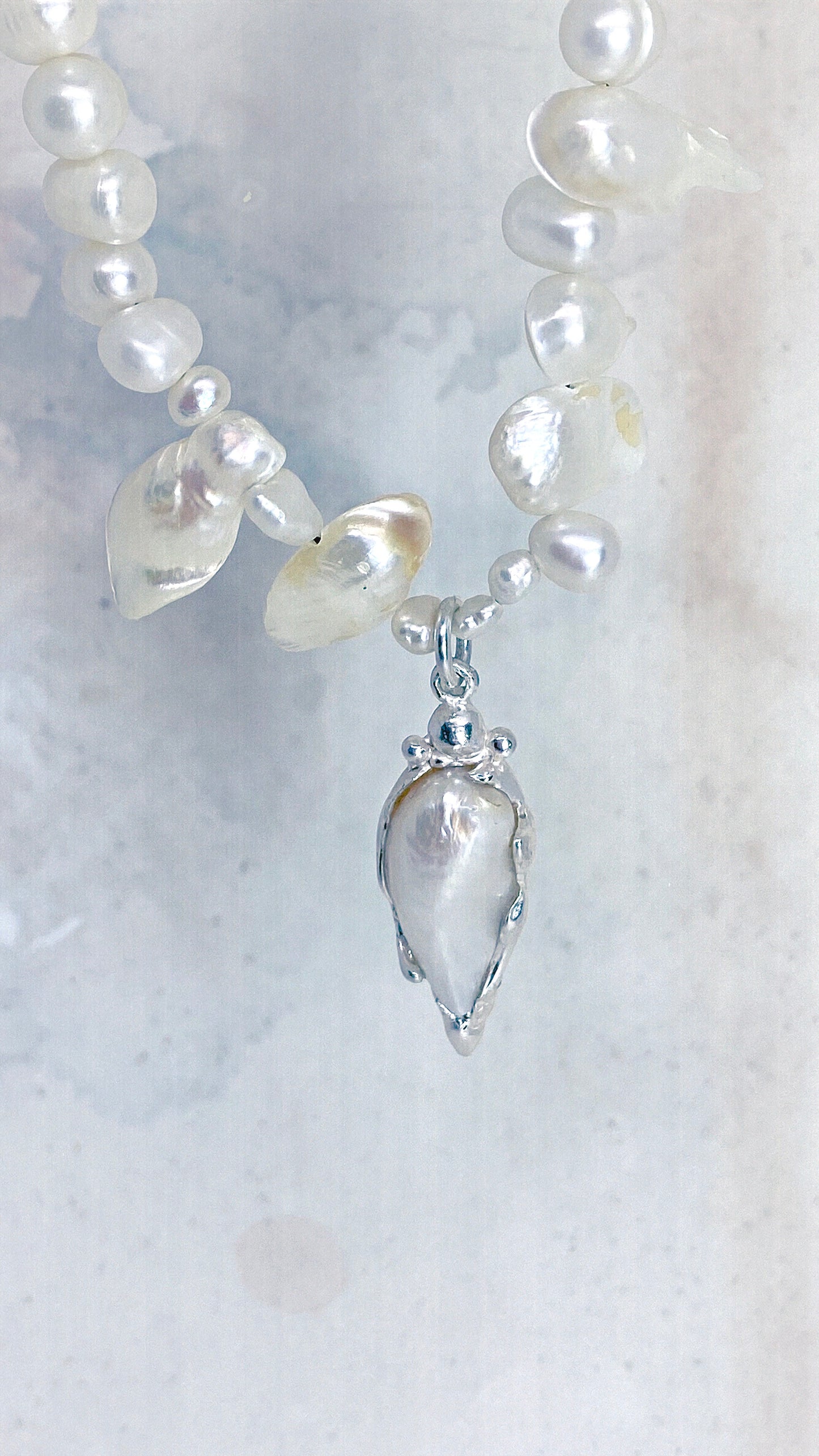 baroque blister teardrop pendant on flowing fresh water pearl strand