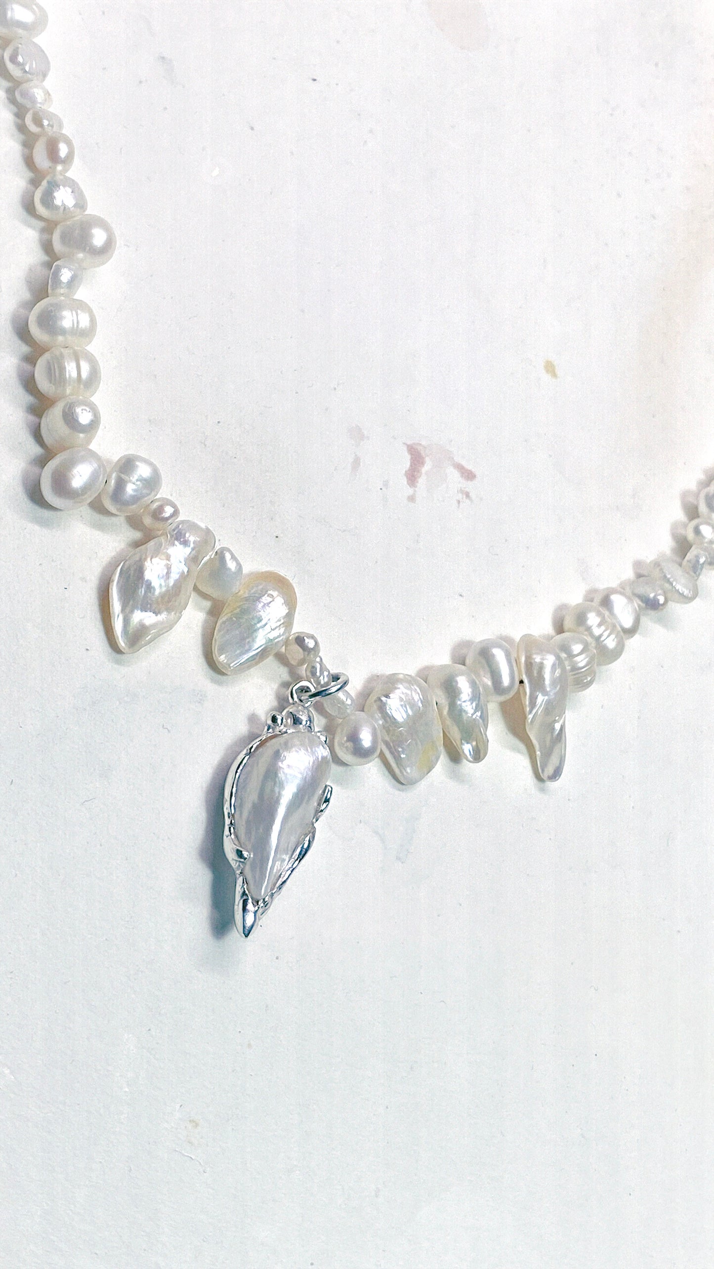 baroque blister teardrop pendant on flowing fresh water pearl strand