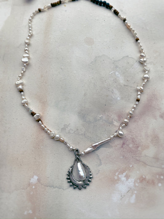 moon cradled fresh water pearl on textured strand