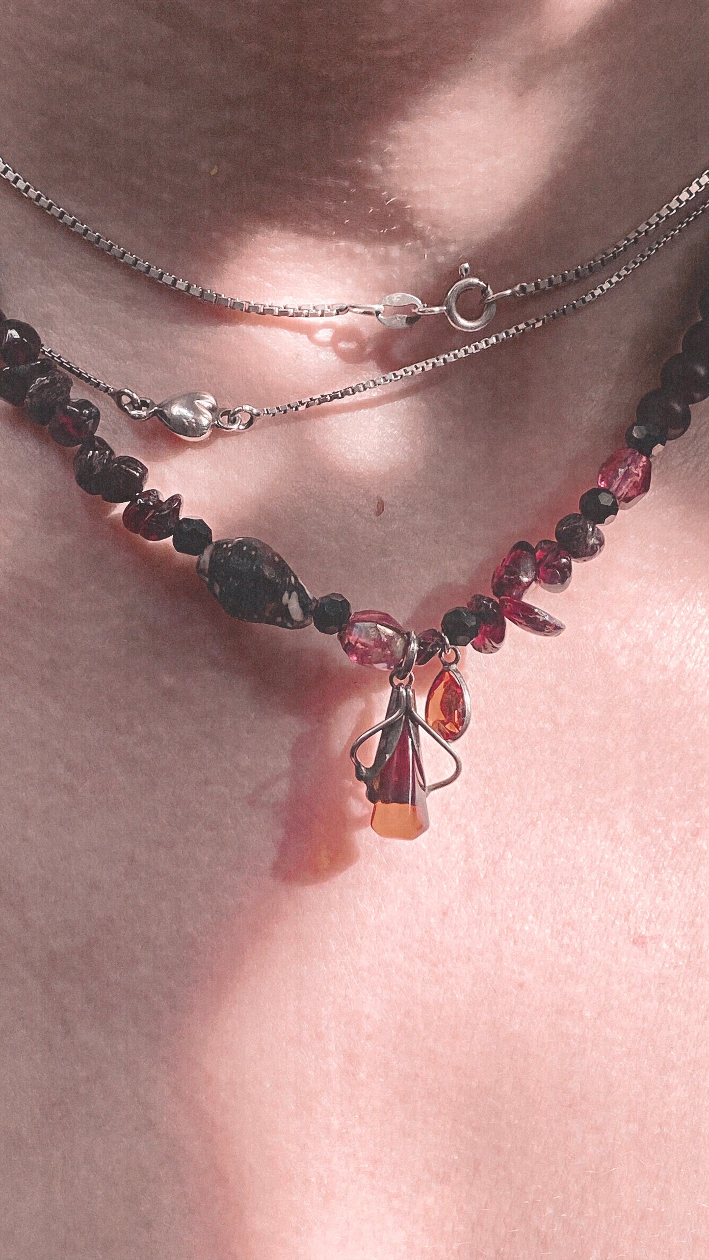 amber droplet and mini fire droplet on textured garnet, seashell, glass