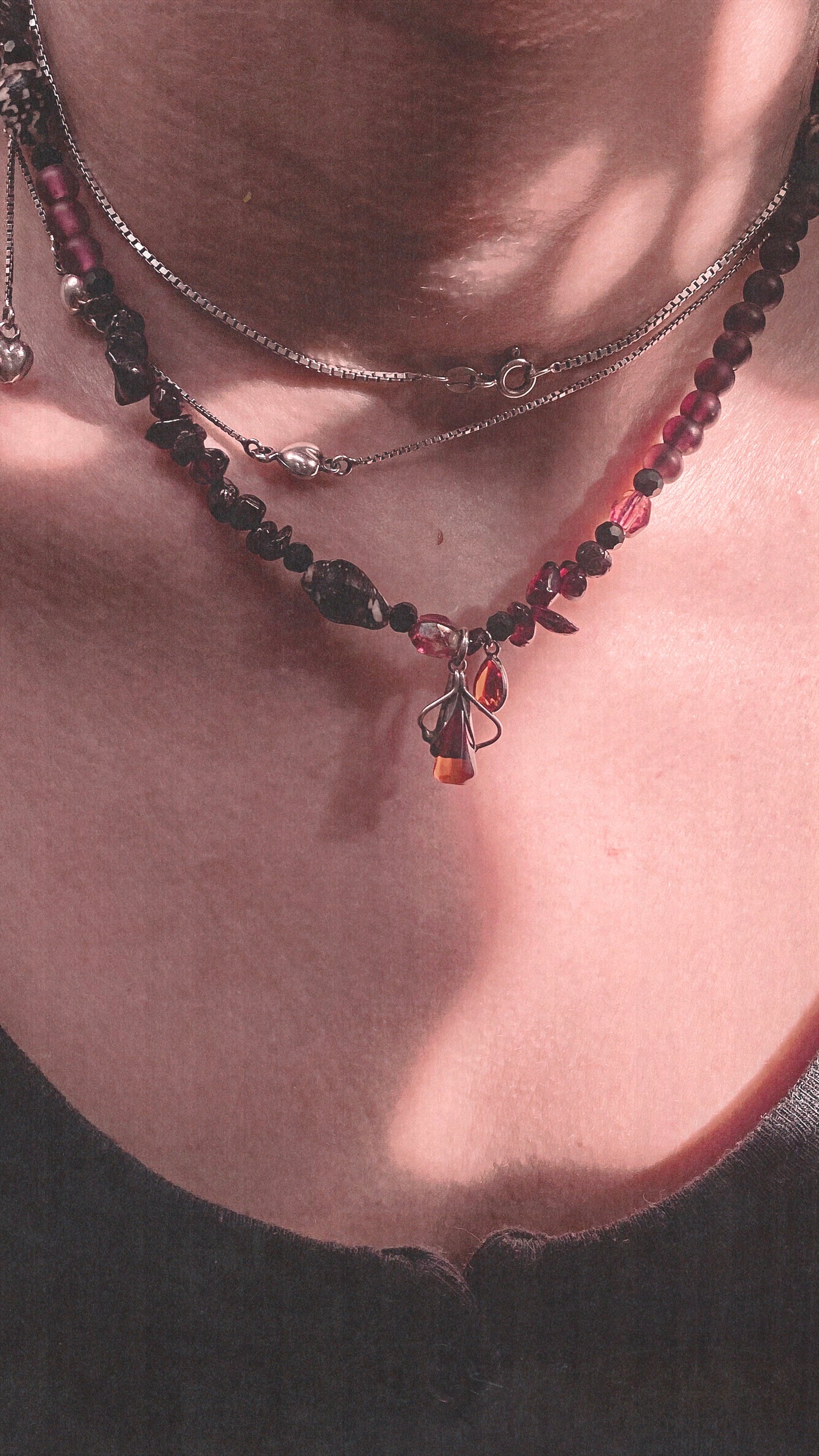amber droplet and mini fire droplet on textured garnet, seashell, glass