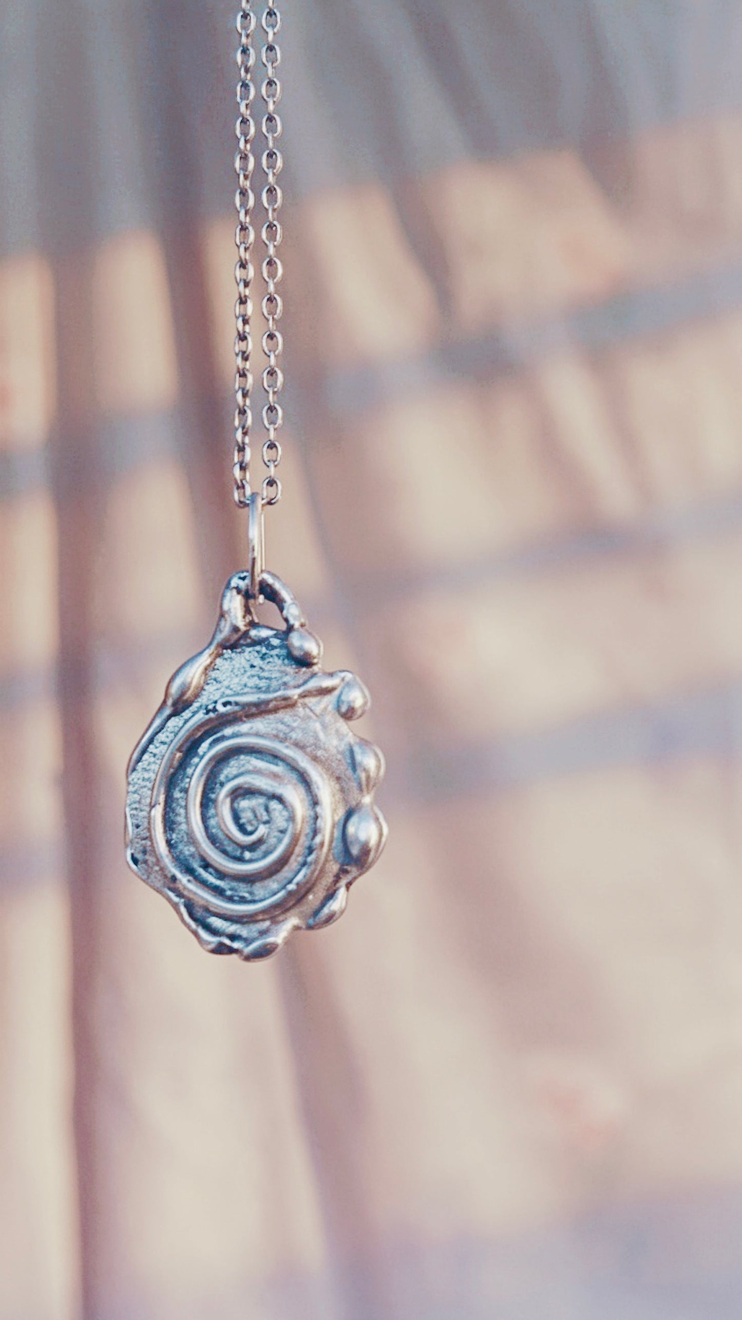 swirl // one of a kind silver coin spiral charm